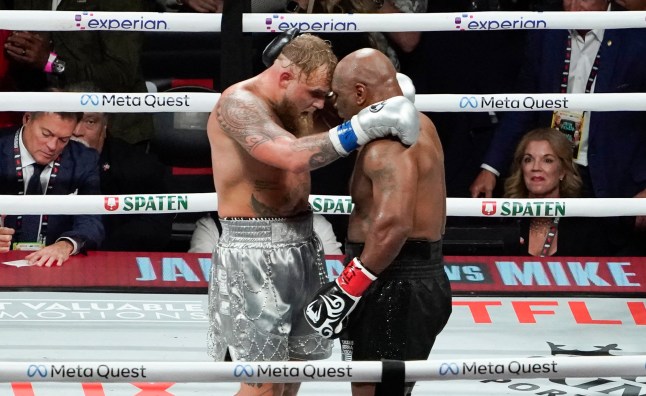 TOPSHOT - US retired pro-boxer Mike Tyson (R) and US YouTuber/boxer Jake Paul (L) hug after Paul defeated Tyson in their heavyweight boxing bout at The Pavilion at AT&T Stadium in Arlington, Texas, November 15, 2024. (Photo by TIMOTHY A. CLARY / AFP) (Photo by TIMOTHY A. CLARY/AFP via Getty Images)