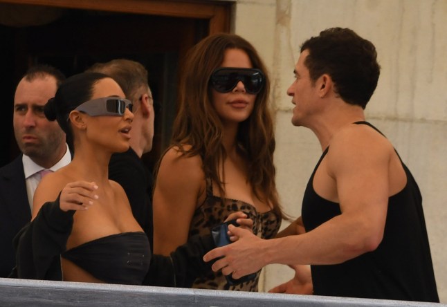 Kim Kardashian, Khloe Kardashian and Orlando Bloom on a balcony ahead of Jeff Bezos and Lauren Sanchez's wedding.