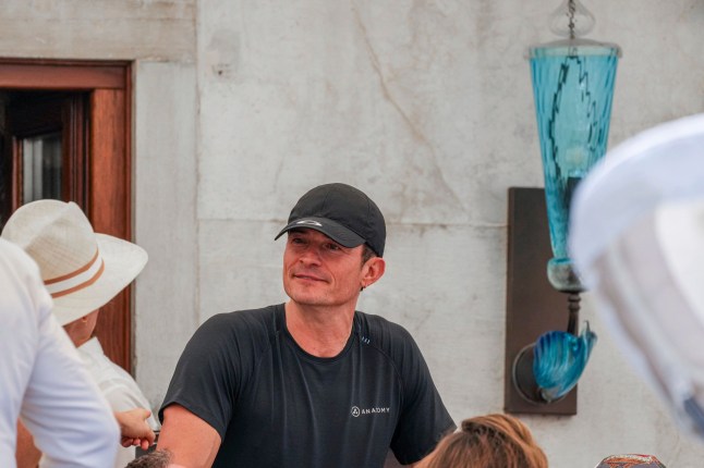 Orlando Bloom leaves his hotel, Friday, June 27, 2025 ahead of the anticipated wedding celebrations of Jeff Bezos and Lauren Sanchez. (AP Photo/Antonio Calanni)