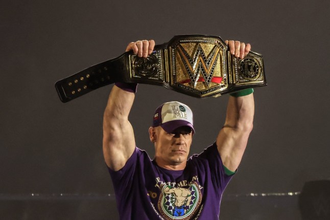 US wrestler John Cena holds his championship belt in the ring during a presentation on the eve of his match for the undisputed WWE Championship against CM Punk at Kingdom Arena in Riyadh on June 27, 2025. (Photo by Fayez Nureldine / AFP) (Photo by FAYEZ NURELDINE/AFP via Getty Images)