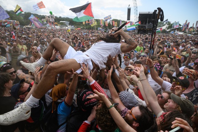 GLASTONBURY, ENGLAND - JUNE 28: Bobby Vylan of Bob Vylan crowdsurfs in front of the West Holts stage during day four of Glastonbury festival 2025 at Worthy Farm, Pilton on June 28, 2025 in Glastonbury, England. Established by Michael Eavis in 1970, Glastonbury has grown into the UK's largest music festival, drawing over 200,000 fans to enjoy performances across more than 100 stages. In 2026, the festival will take a fallow year, a planned pause to allow the Worthy Farm site time to rest and recover. (Photo by Leon Neal/Getty Images)