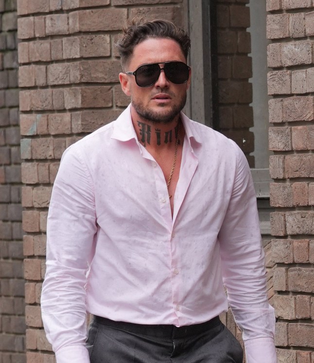Stephen Bear wearing sunglasses in a white top