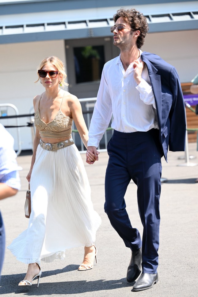 LONDON, ENGLAND - JULY 13: Sienna Miller, wearing Ralph Lauren, and Oli Green attend day fourteen of the Wimbledon Tennis Championships at the All England Trennis and Croquet Club at on July 13, 2025 in London, England. (Photo by Karwai Tang/Getty Images for Ralph Lauren)