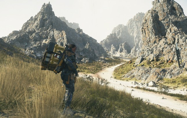 Norman Reedus chilling by mountains in Death Stranding 2