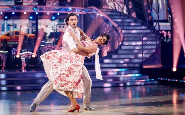 Balvinder Sopal and Julian Caillon on Strictly Come Dancing, week eight. Balvinder in white and pink dress, Julian in white shirt, holding Balvinder as she leans backwards.