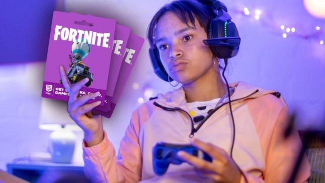 A gamer holding Fortnite gift cards