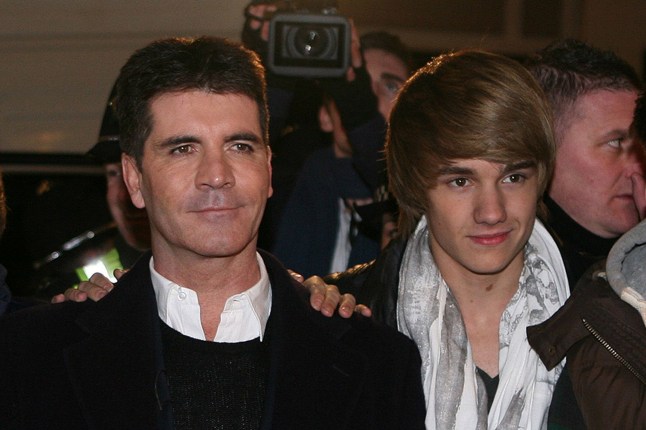 (L-R) Harry Styles, Nial Horan, Louis Tomlinson, Simon Cowell, Liam Payne and Zayn Malik of One Direction attend the One Direction performance ahead of The X Factor final this weekend at Queen Square on December 7, 2010 in Wolverhampton, England.