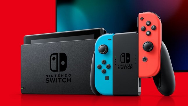 Nintendo Switch console and controller stood alongside a TV on a red background