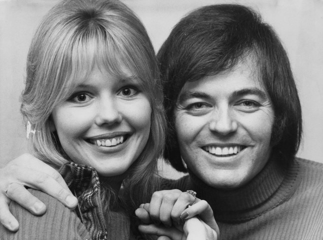 Tony Blackburn And Tessa Wyatt smiling in a black and white photo together.