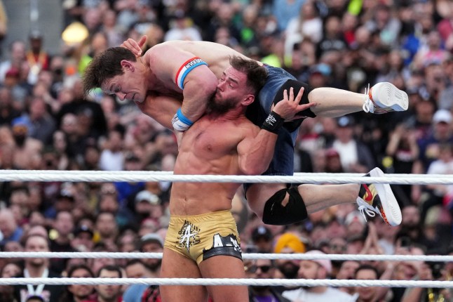 Apr 1, 2023; inglewood, CA, USA; John Cena (denim shorts) and Austin Theory (gold shorts) during Wrestlemania Night 1 at SoFi Stadium. Mandatory Credit: Joe Camporeale-USA TODAY Sports