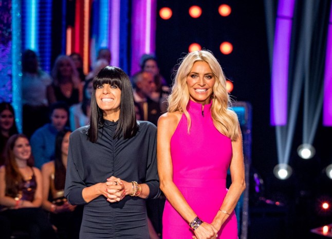 Claudia Winkleman and Tess Daly host Strictly Come Dancing together, wearing a black and pink dress each.