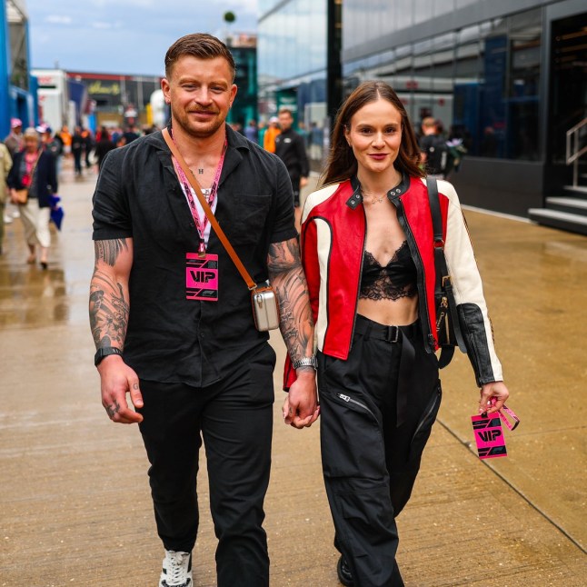NORTHAMPTON, ENGLAND - JULY 6: British Olympic swimmer Adam Peaty and Holly Ramsay walk in the paddock during the F1 Grand Prix of Great Britain at Silverstone Circuit on July 6, 2025 in Northampton, United Kingdom. (Photo by Kym Illman/Getty Images)