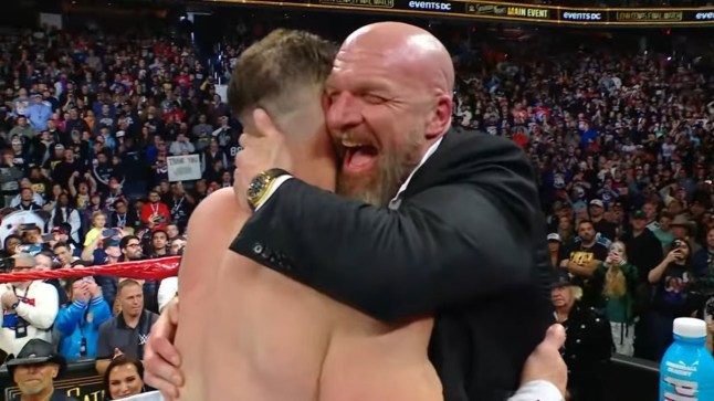 Triple H laughs as he hugs John Cena after the WWE legend's last ever match at Saturday Night's Main Event