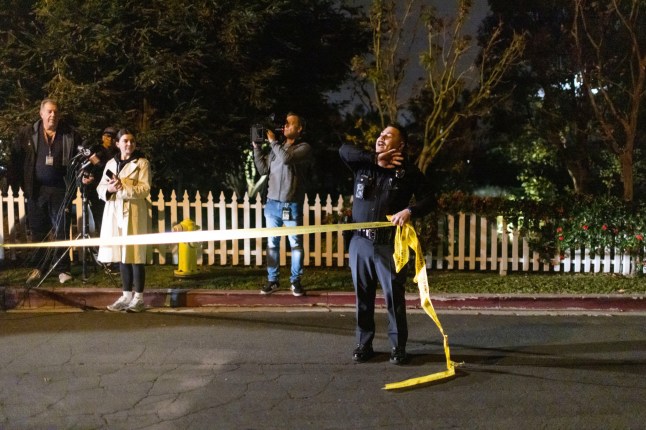 A police officer blocks off a street near Rob Reiner's residence Sunday, Dec. 14, 2025, in the Brentwood section of Los Angeles. (AP Photo/Ethan Swope)