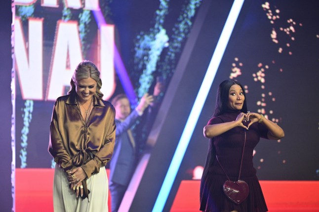 Erika Kirk, left, and Nicki Minaj stand on stage during Turning Point USA's AmericaFest 2025, Sunday, Dec. 21, 2025, in Phoenix. (AP Photo/Jon Cherry)
