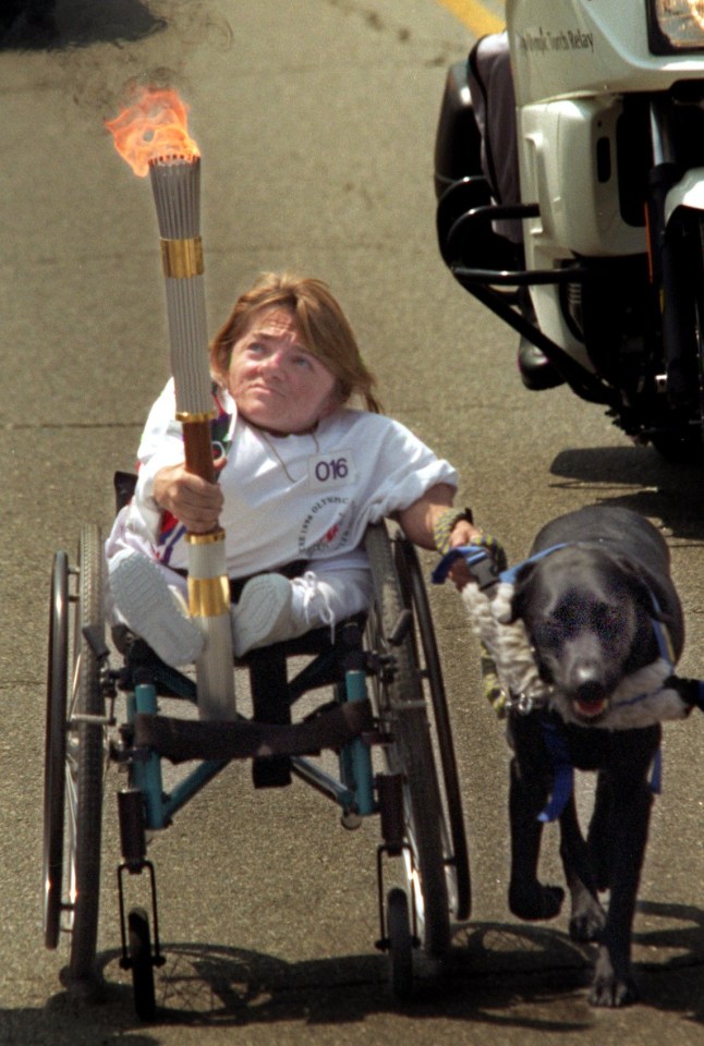 ME.torch.1.0427.RG ???? Melanie Watson is pulled along Western Avenue by her dog "Roamer," during the first day of the cross country Olympic Torch Relay, Saturday, April 27, 1996. (Photo by Robert Gauthier/Los Angeles Times via Getty Images)