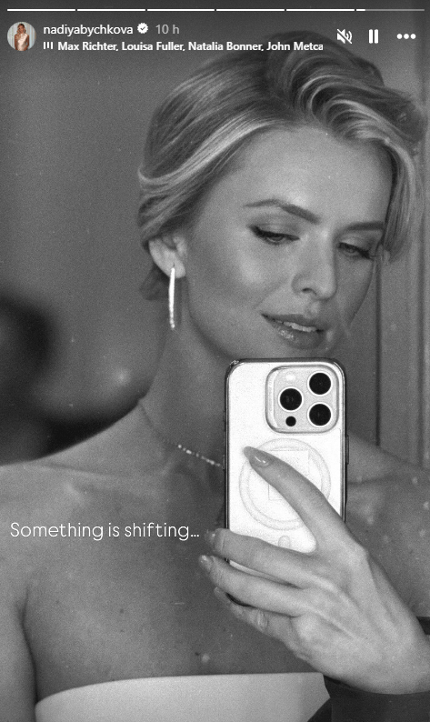 Nadiya Bychkova poses for a mirror selfie with her phone